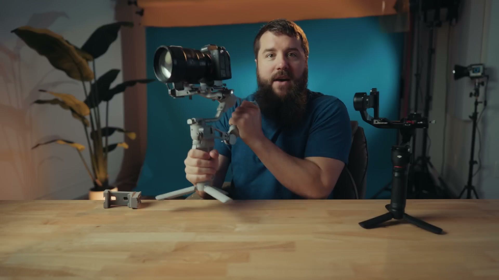 Matt holding the DJI RS4 Mini two handed with the lightweight stabilizer arm from the combo pack attached to the side