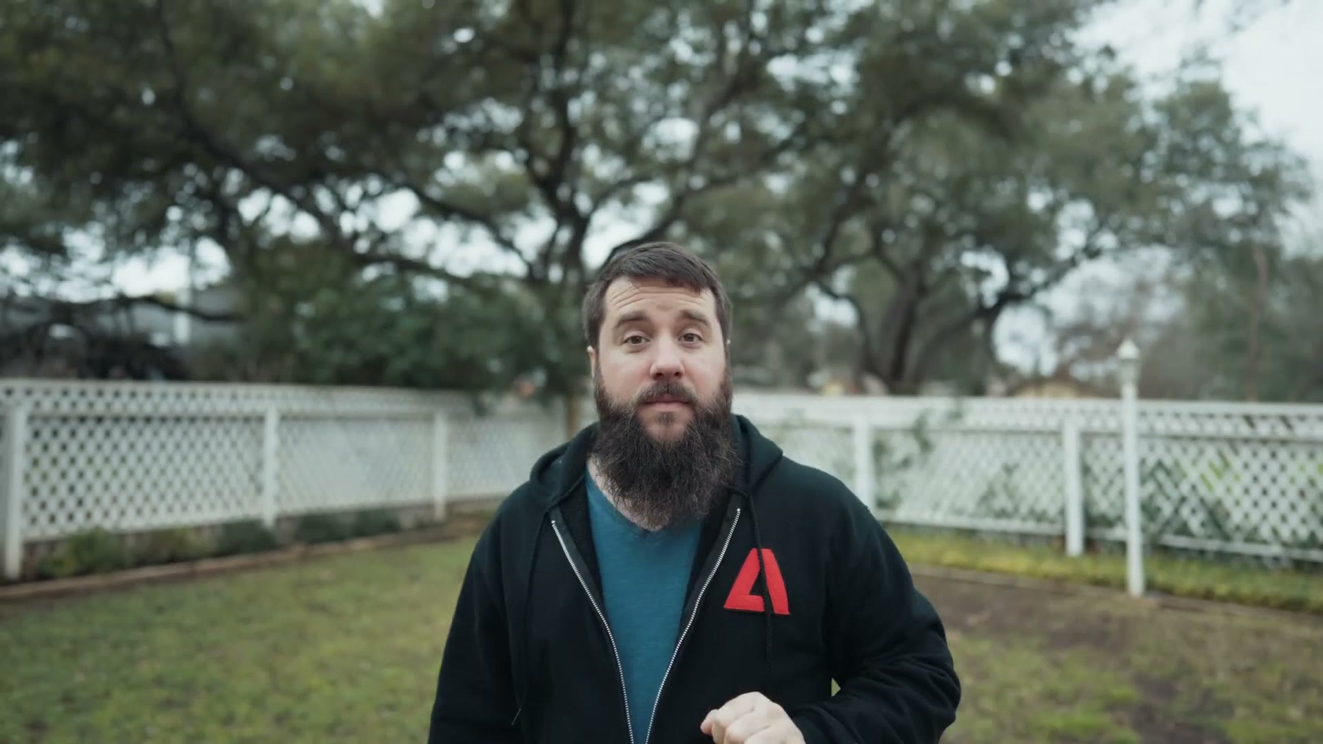 Matt standing in a backyard in front of a white fence, framed by the camera on the gimbal while the tracking module follows him