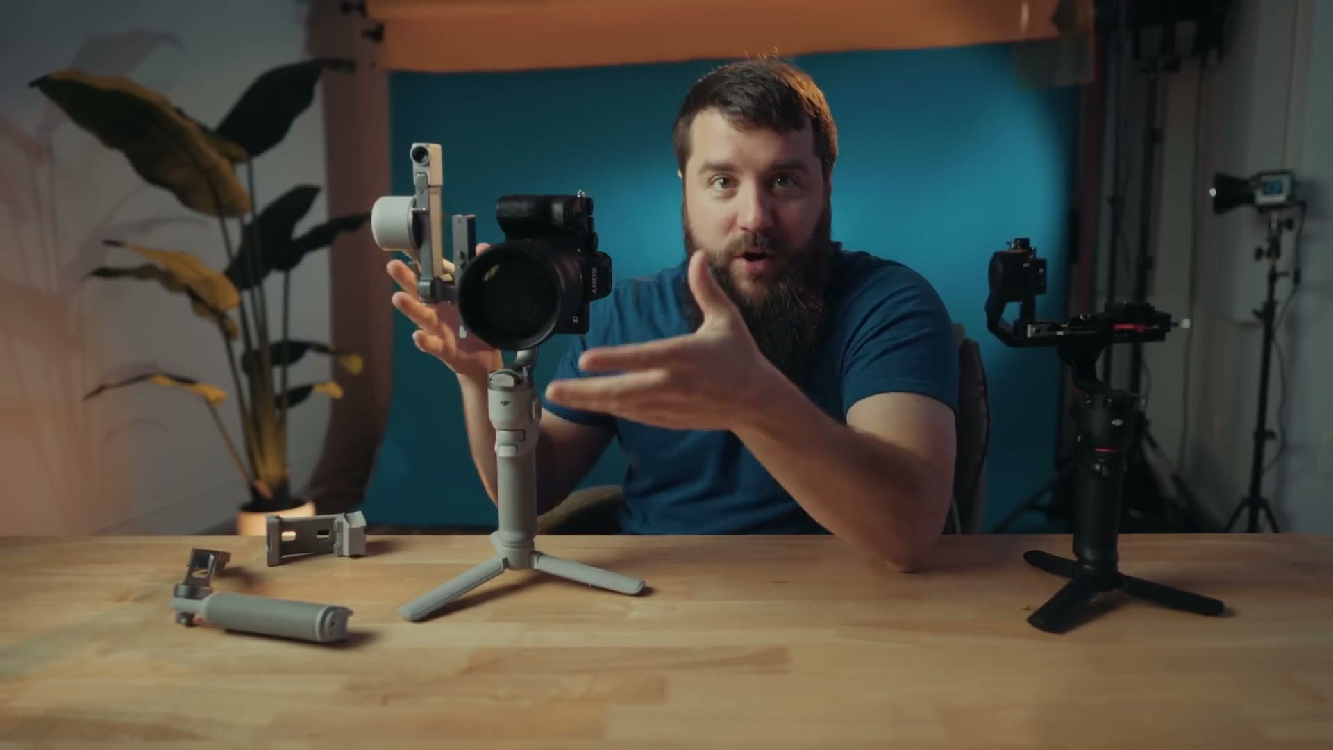 Matt holding the white DJI RS4 Mini with a mirrorless camera mounted in the vertical orientation