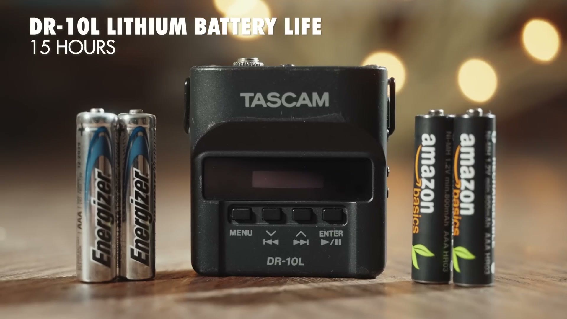 A Tascam DR-10L on a table between Energizer lithium and Amazon Basics rechargeable AAA batteries, with the on-screen title DR-10L lithium battery life, 15 hours.