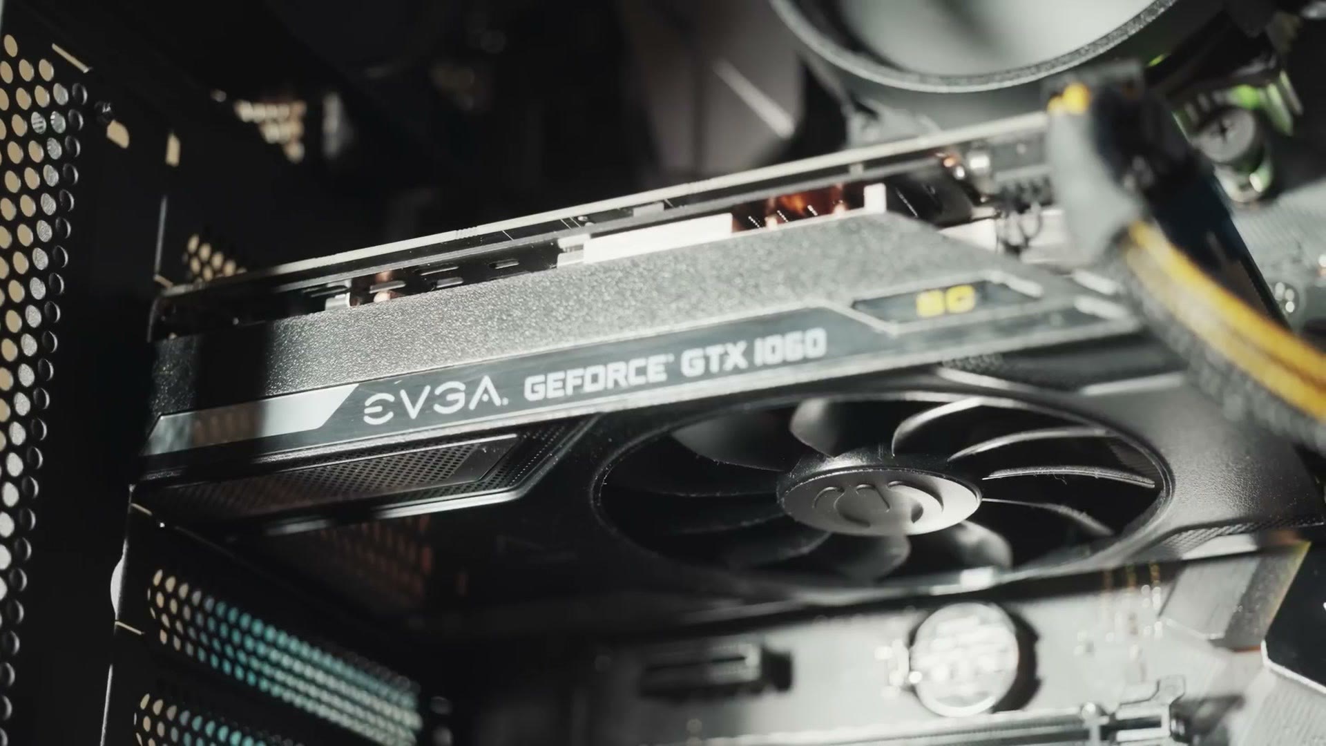 Close-up of an EVGA GeForce GTX 1060 graphics card installed in the build, fan blades visible