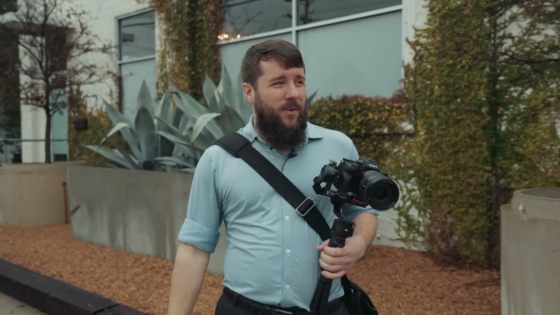 Matt filming establishing shots outside the venue with a camera on a gimbal