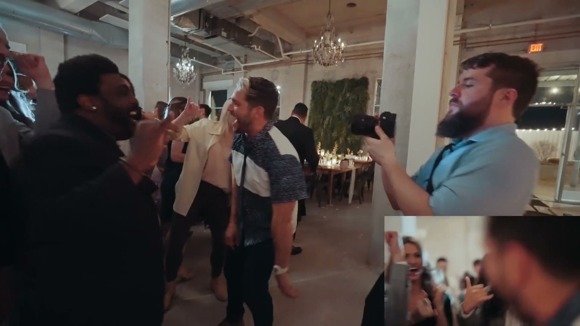 Matt filming guests dancing at a reception