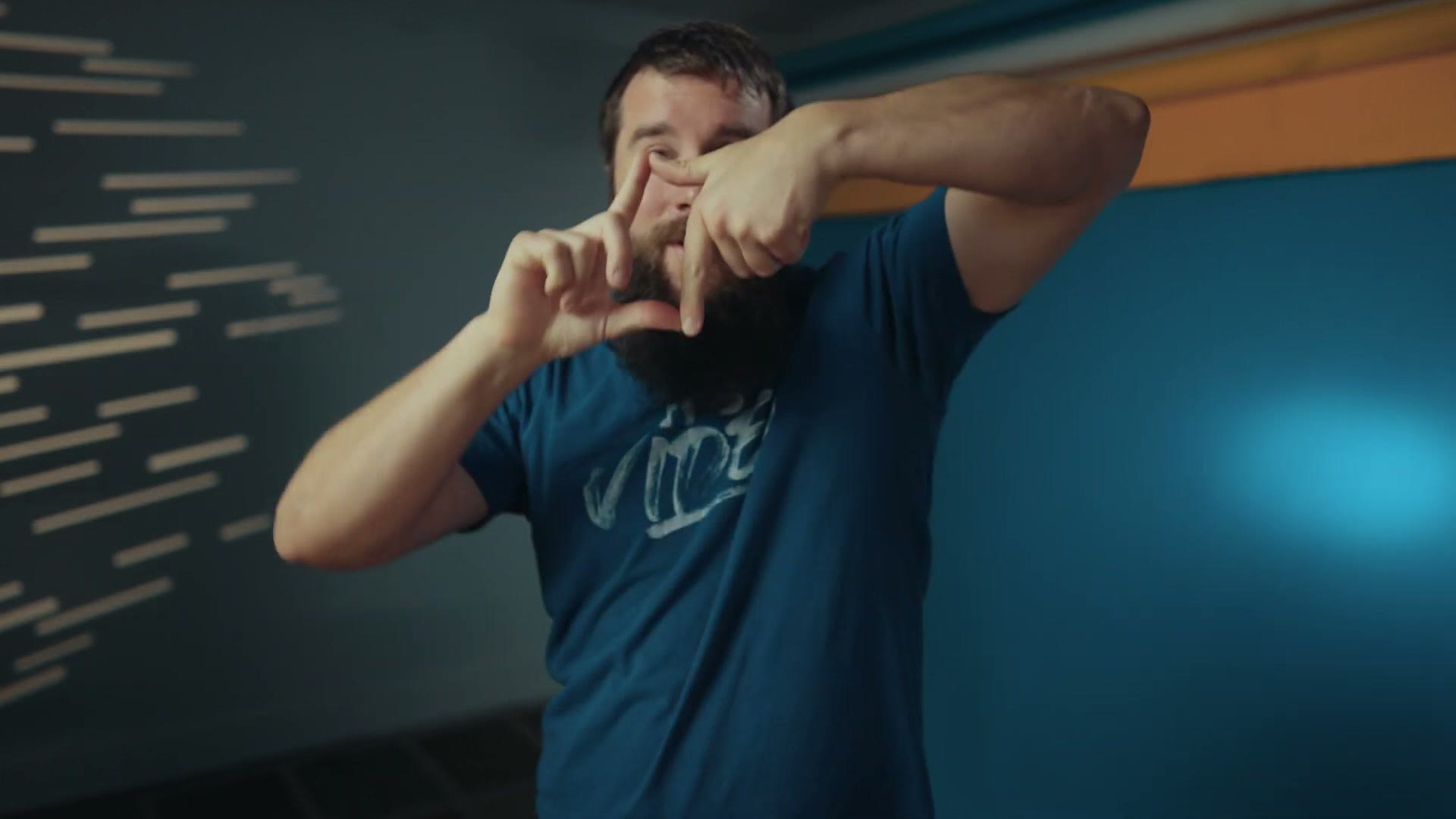 Matt framing a tall vertical rectangle with his hands while talking to camera