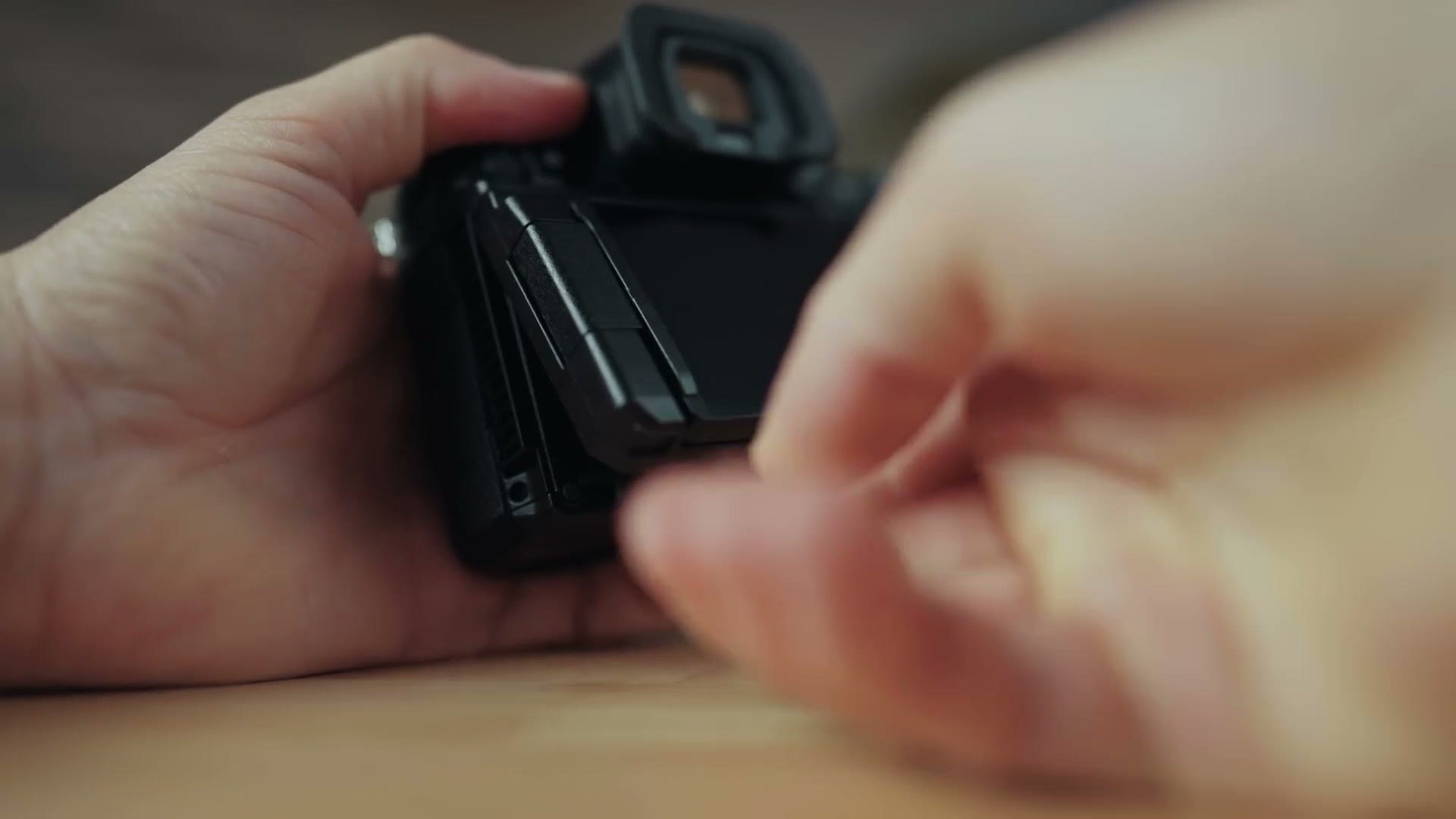 Hand adjusting the articulating and tilting rear screen on the Panasonic GH7