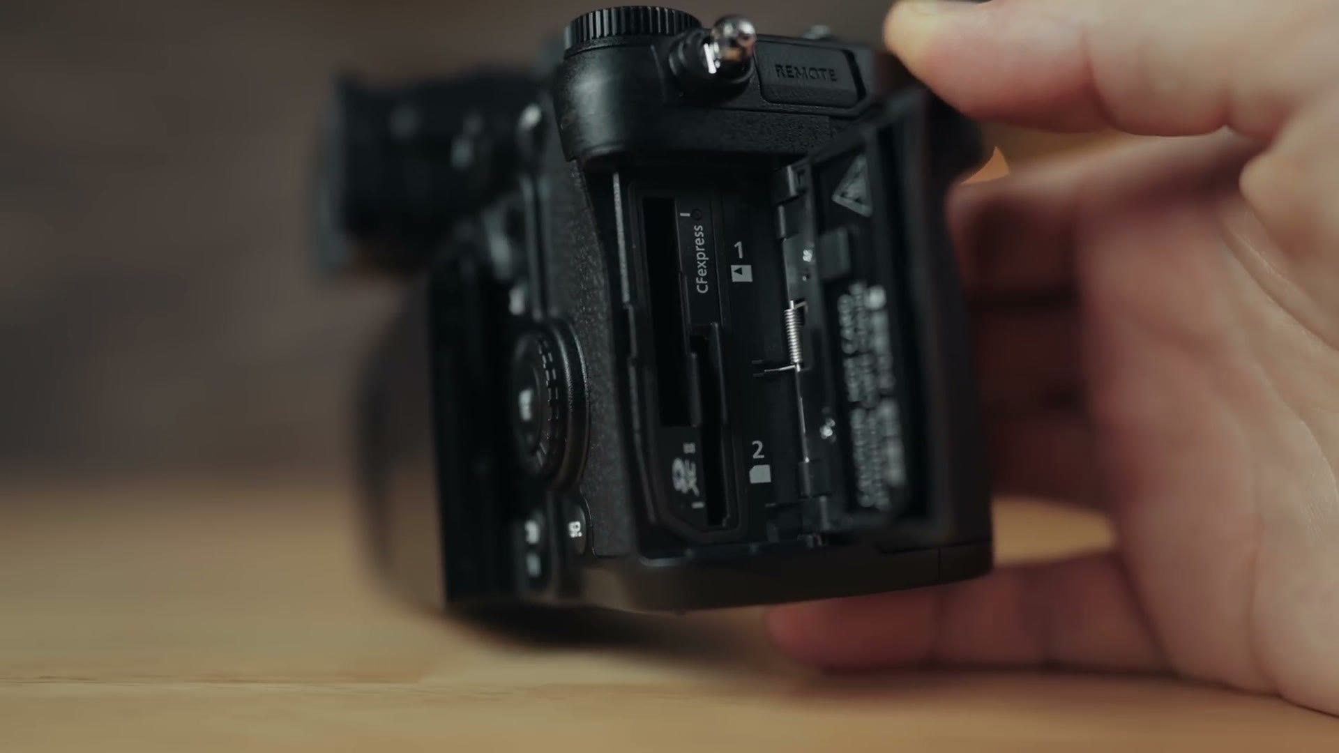 Open memory card door on the Panasonic GH7 showing both card slots