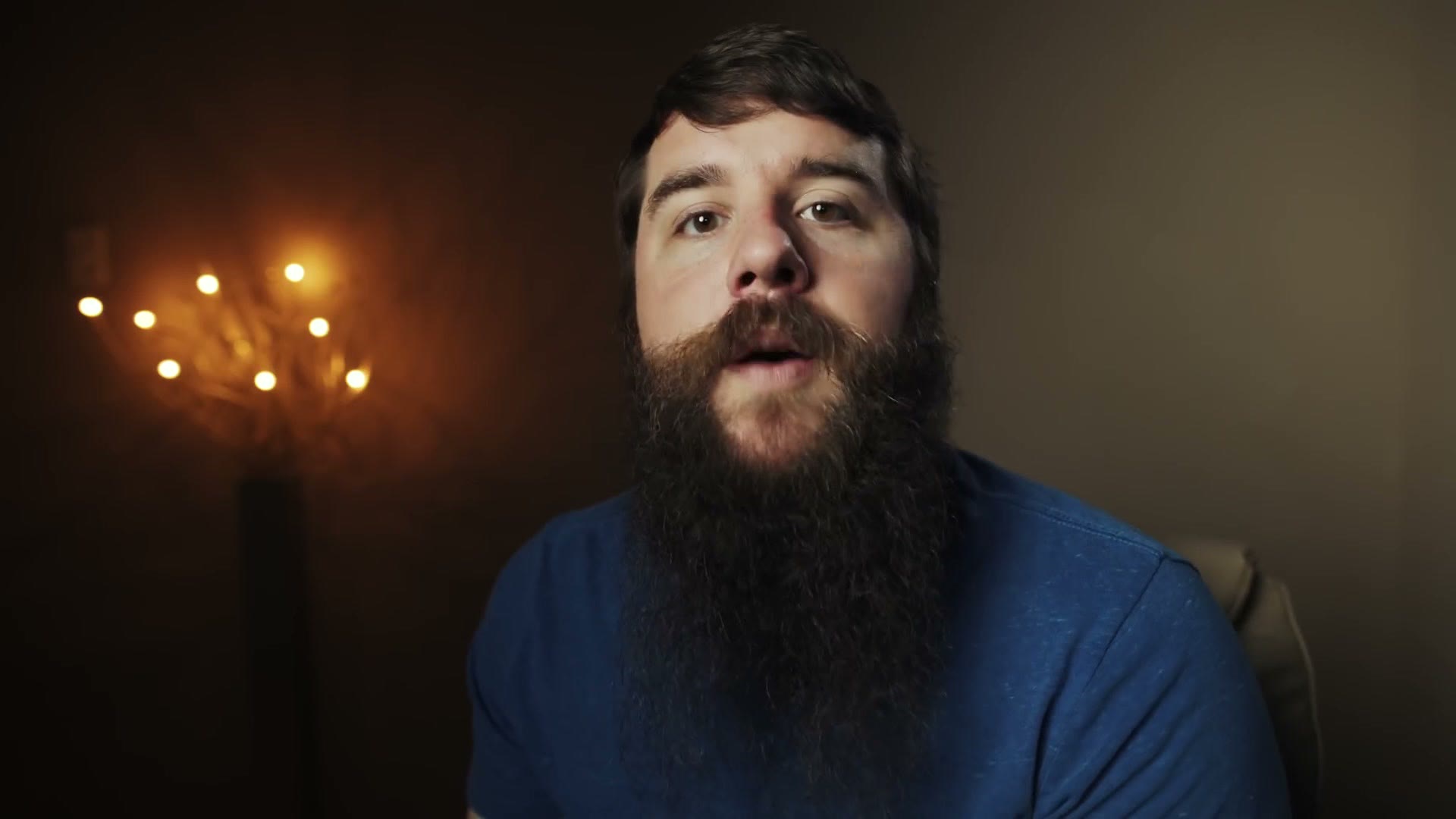 Matt sitting in front of a lamp, sharp and in focus, demonstrating the plane of focus