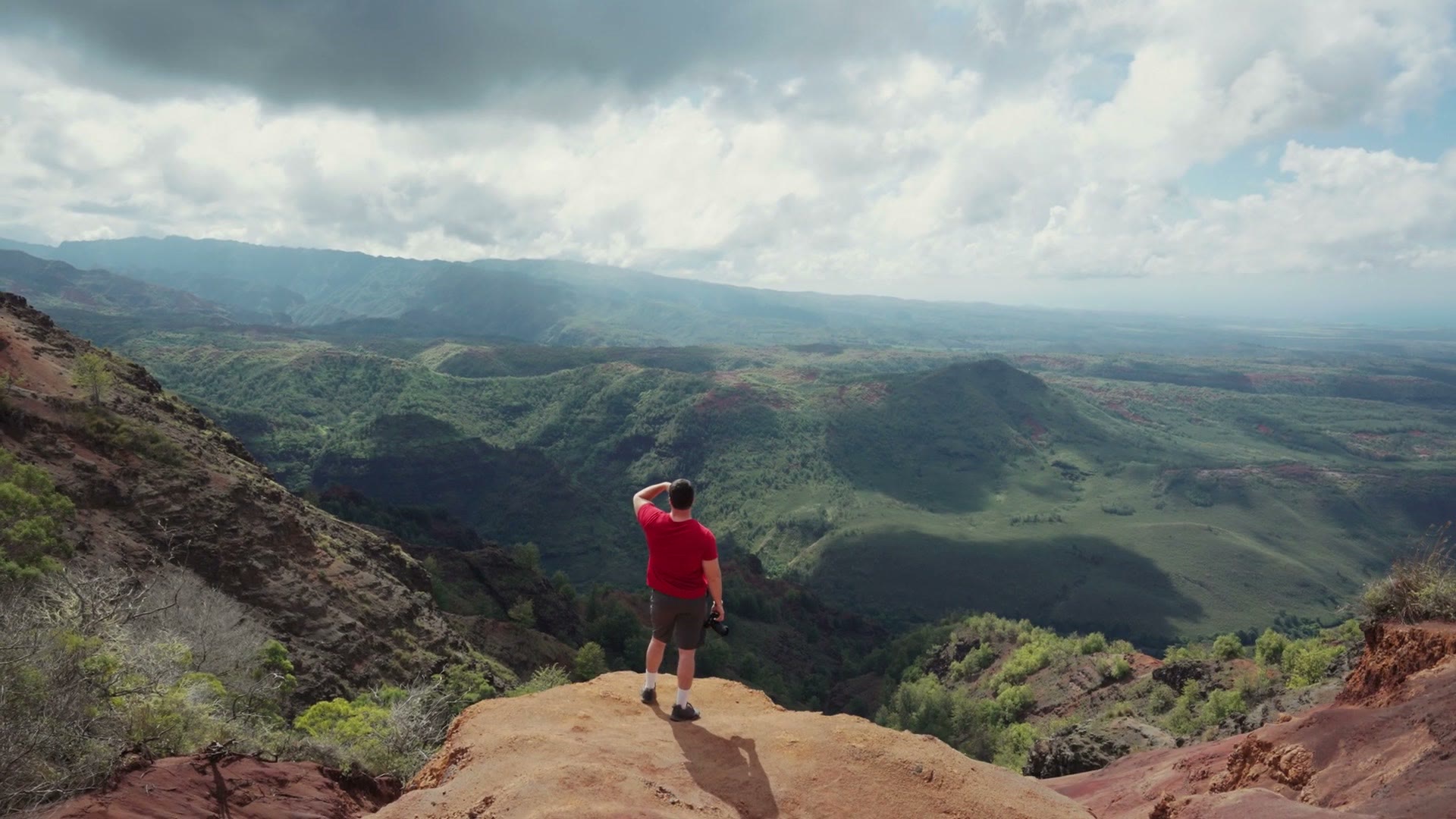 Horizontal shot of a hiker standing on a ridge line in Hawaii, filmed on a Sony a7S III
