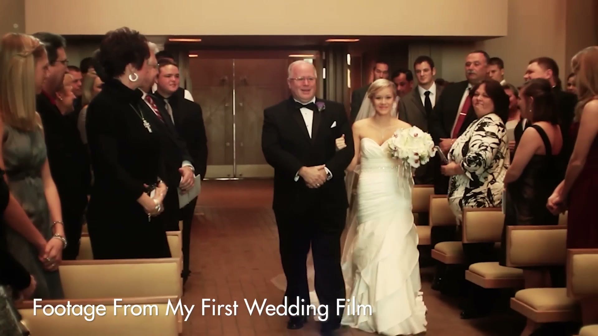 A bride walking down the aisle on her father's arm past standing guests, labelled Footage From My First Wedding Film