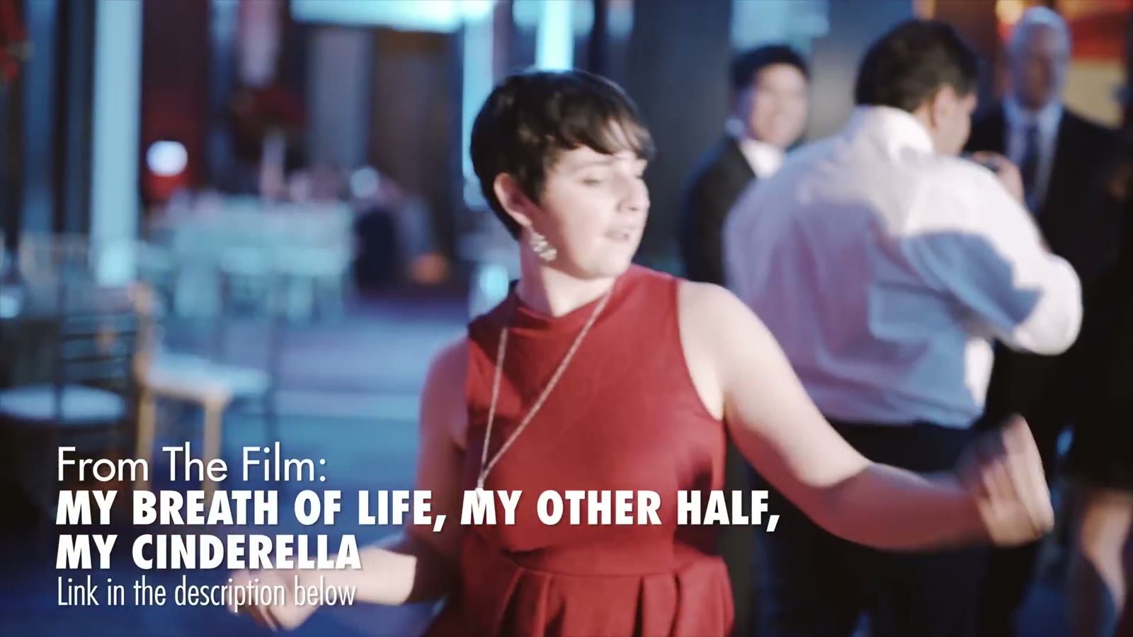 Woman in a red dress dancing at the reception with groomsmen blurred behind her, captioned 'My Breath of Life, My Other Half, My Cinderella'