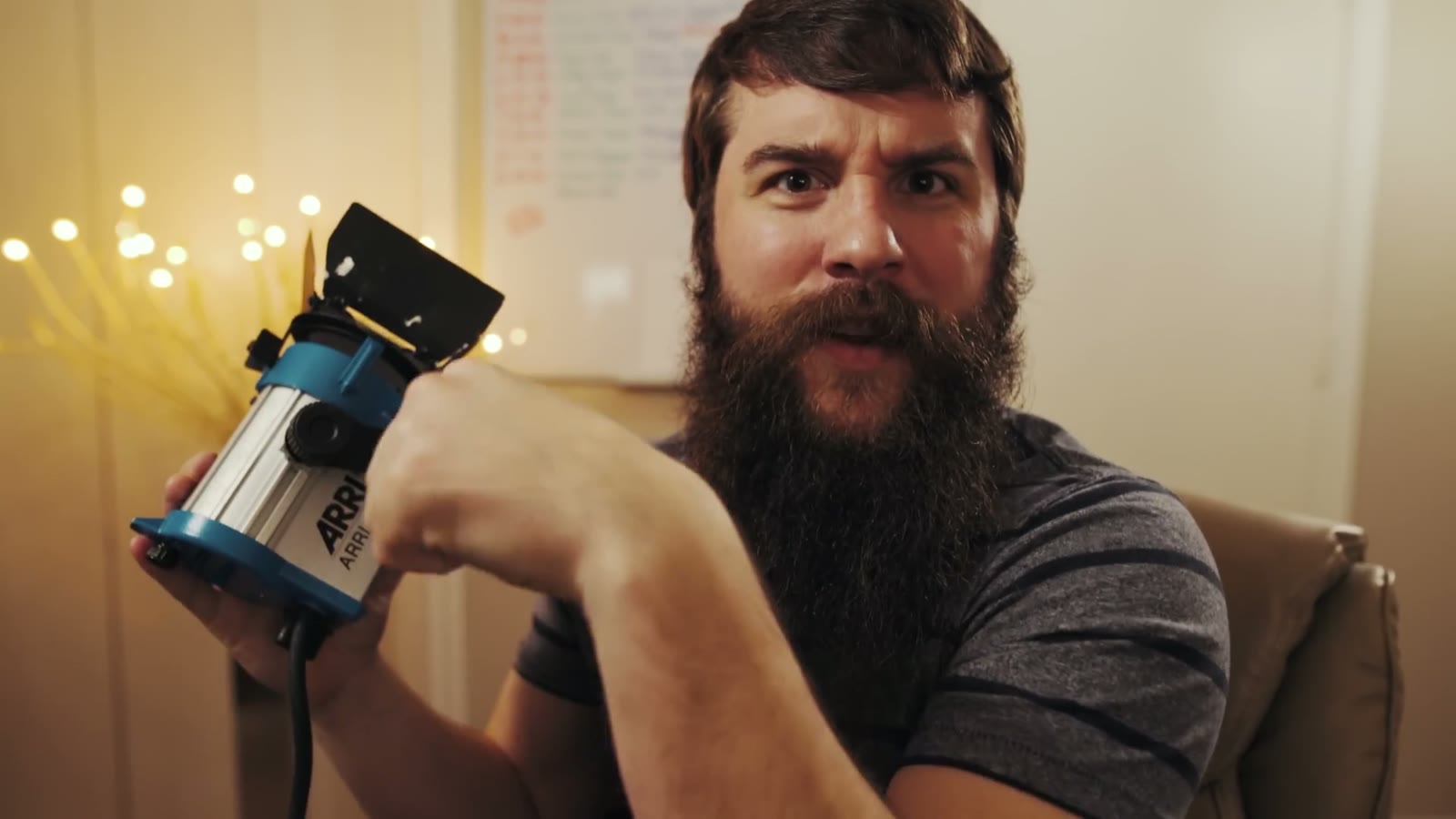 Matt holding the same Arri 150 light with a furrowed brow, mid-sentence