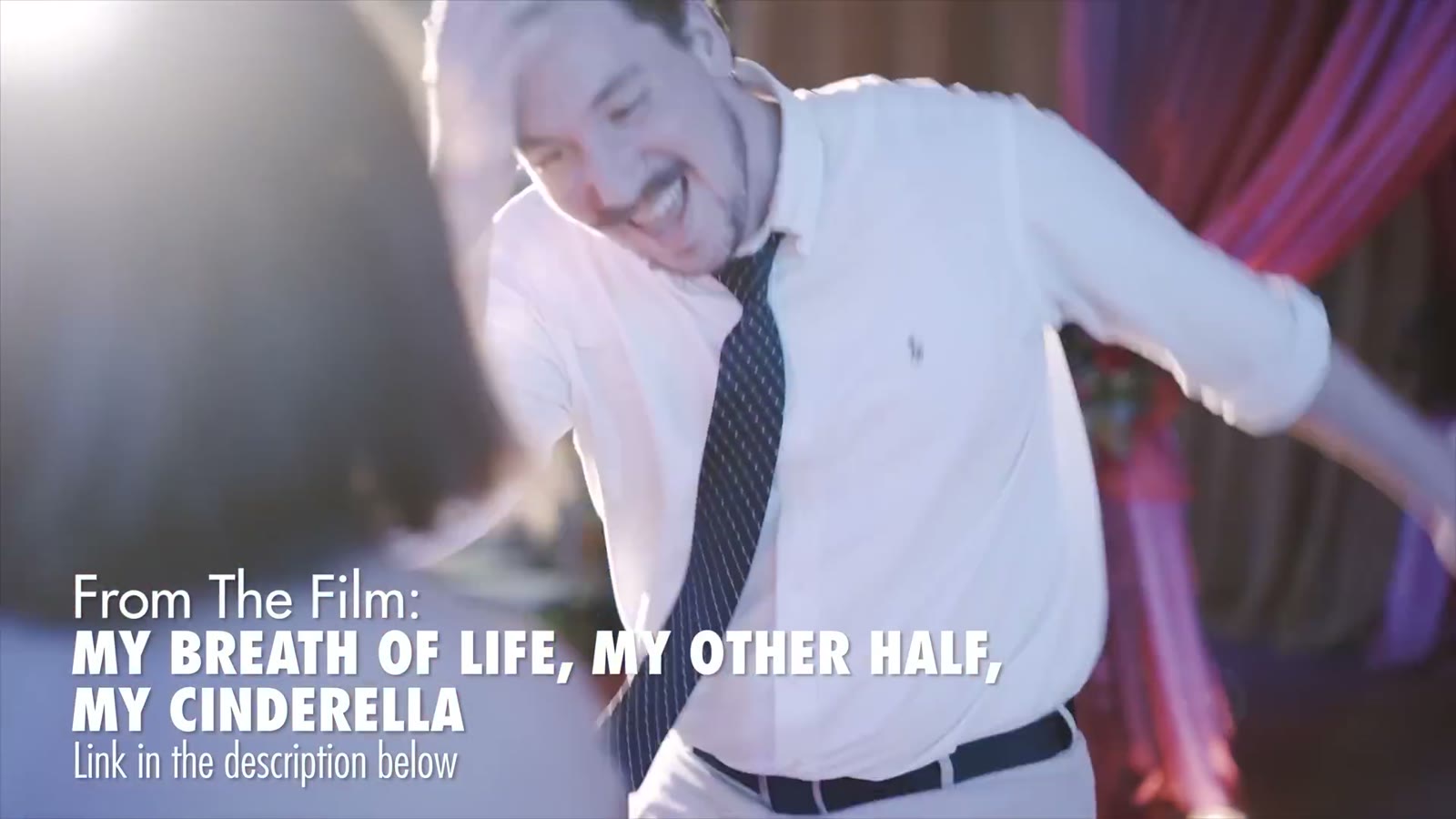 Groom in a white shirt and tie laughing while dancing, captioned 'From The Film: My Breath of Life, My Other Half, My Cinderella'