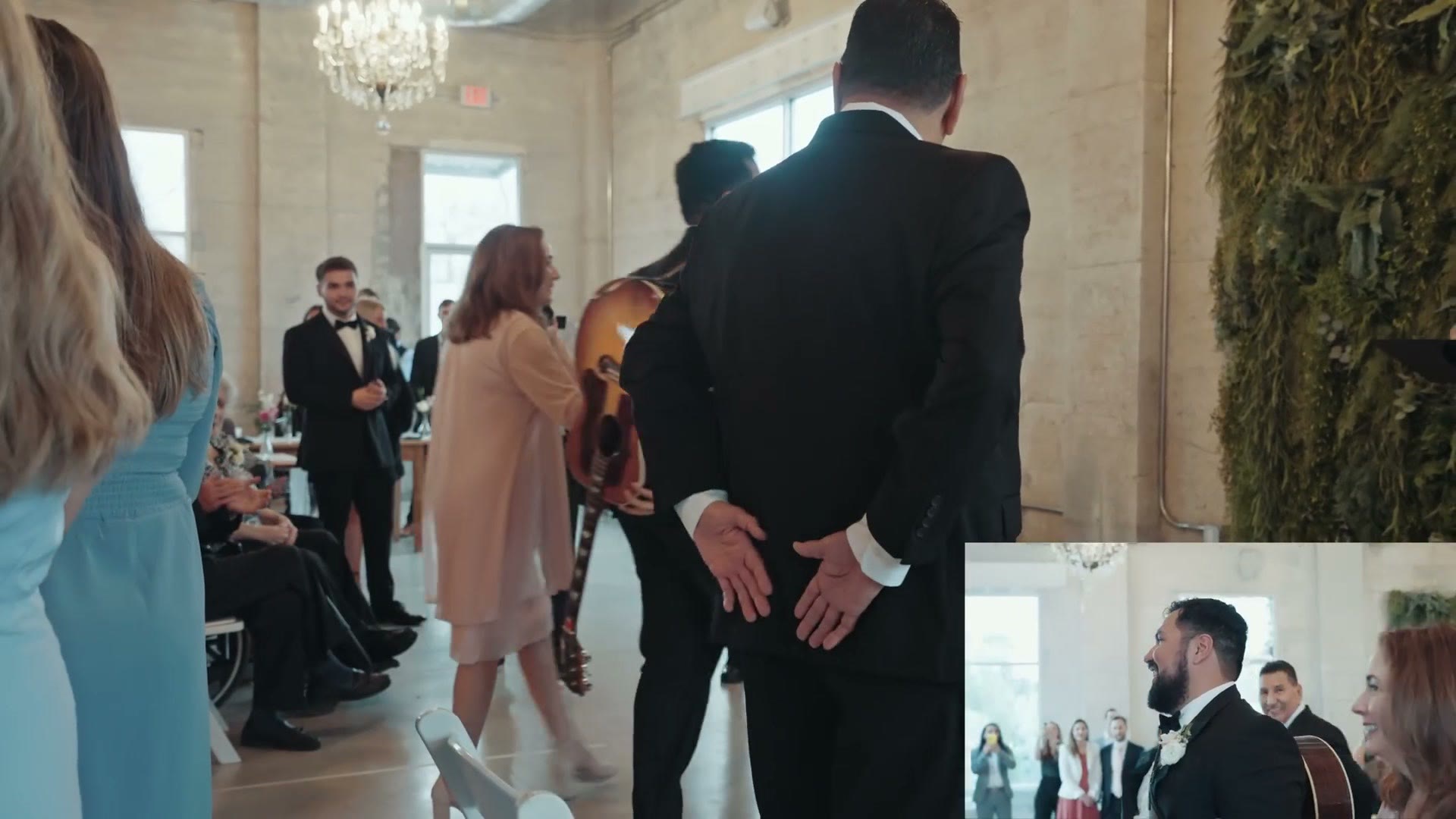 A wedding ceremony taking place indoors with the couple facing the officiant