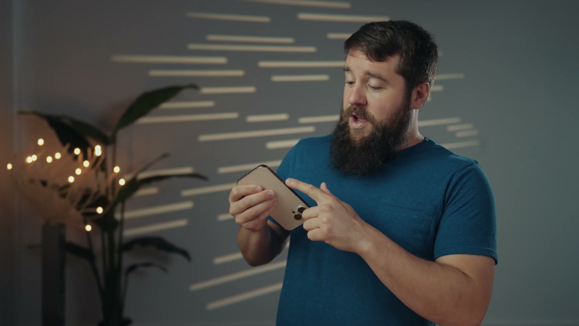 Matt pointing at the Camera Control button on the side of an iPhone