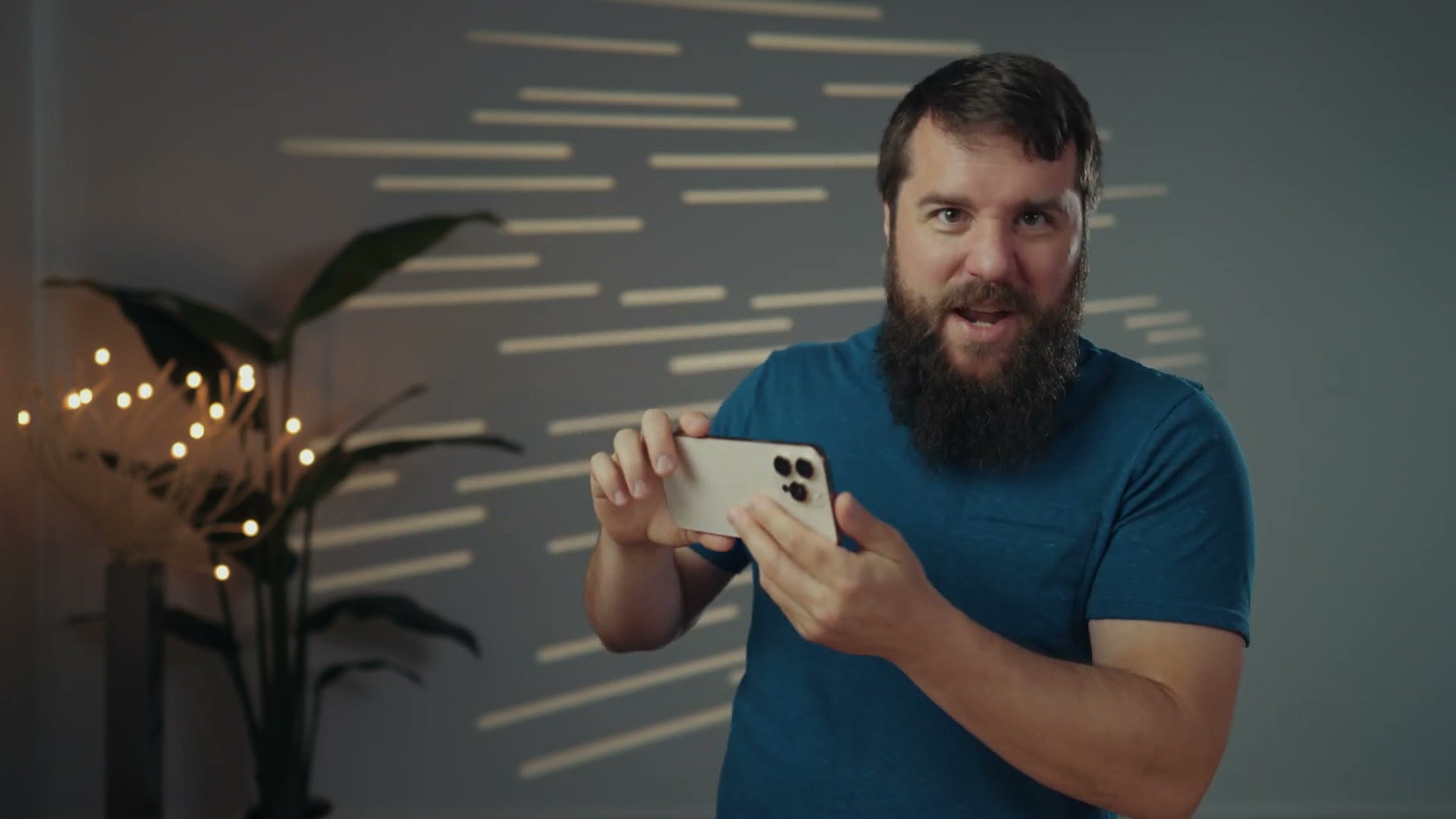 Matt holding an iPhone horizontally with both hands like a camera