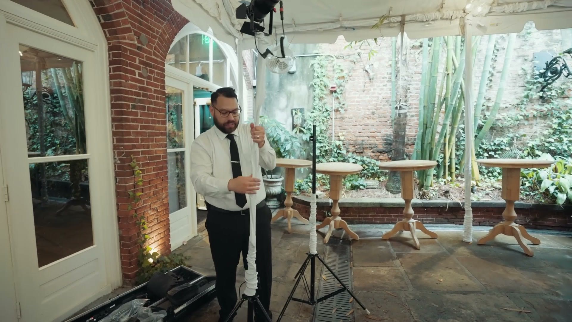 Lit ceremony setup under a tent with light stands in place