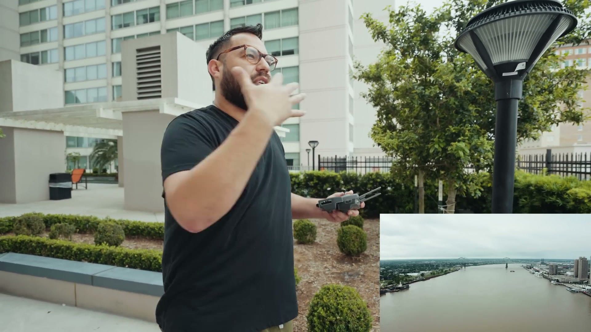 Caleb flying a drone from a hotel pool deck with the drone view inset