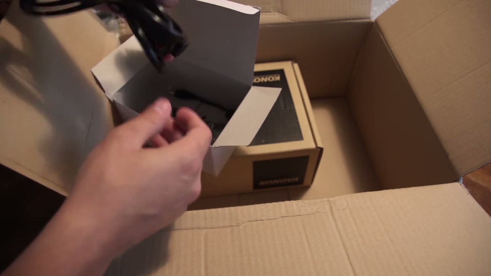 Power adapter being pulled out of its box