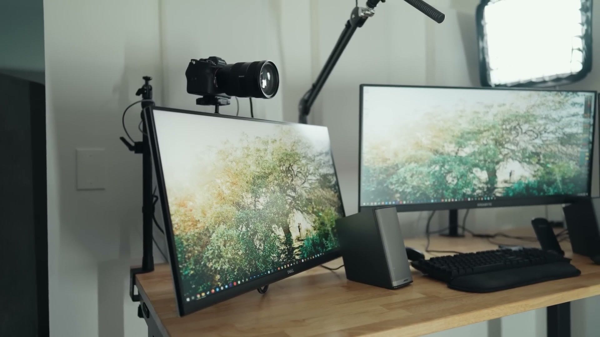 One monitor lowered so the camera sits at eye level