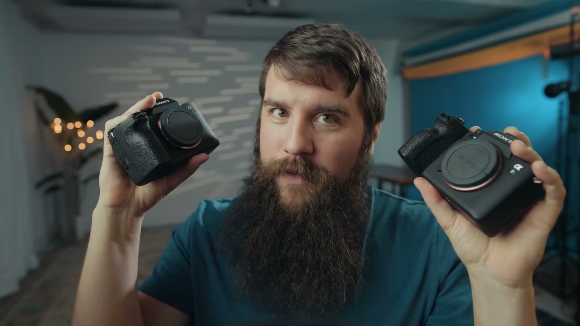 Matt Johnson holding up both the Sony a7 IV and the Sony a7S III to compare them