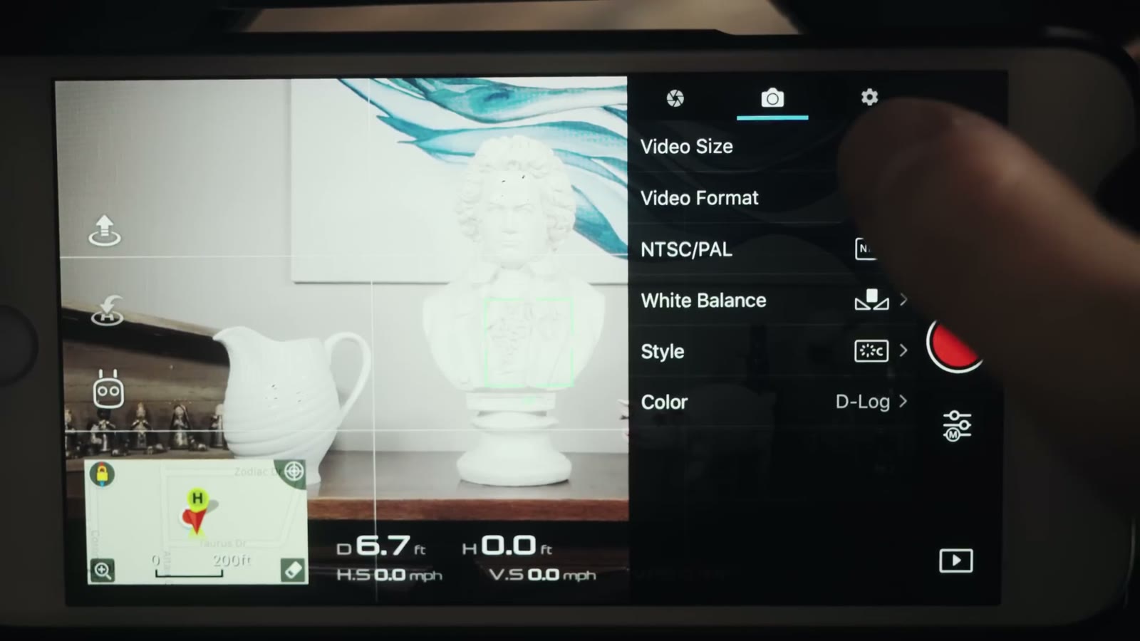 The DJI Go camera menu on a phone showing Video Size, Video Format, NTSC slash PAL, White Balance, Style, and Color set to D-Log