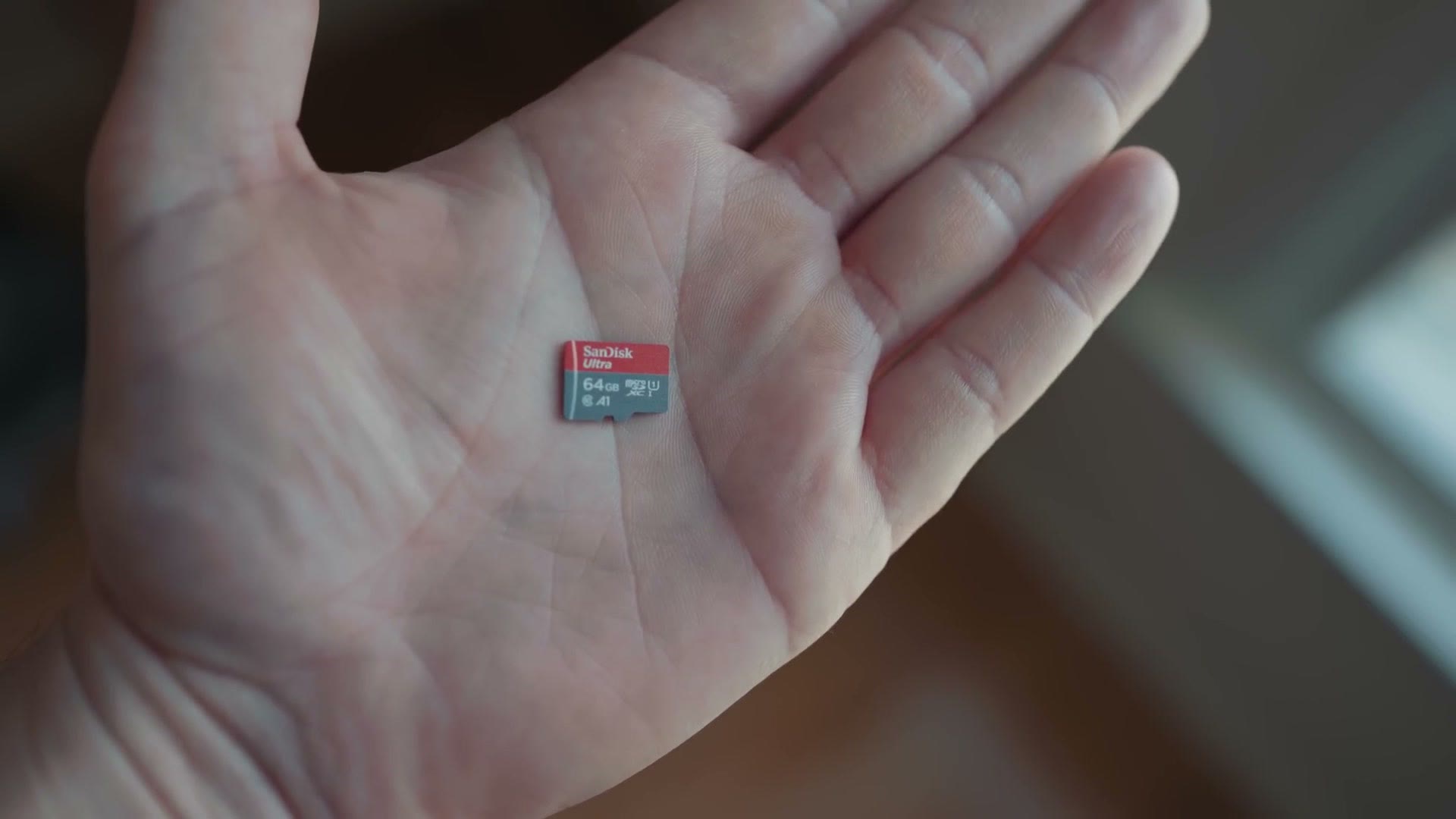 A microSD card held in a palm