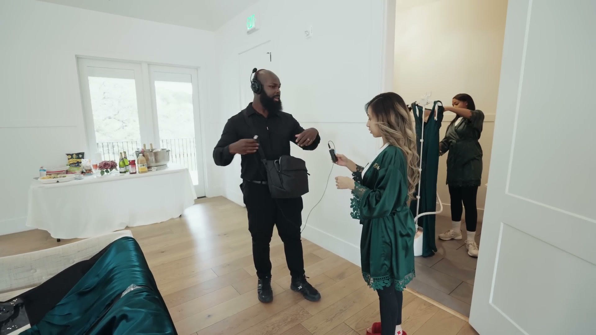 Justin Porter fitting a lavalier microphone on a member of the bridal party