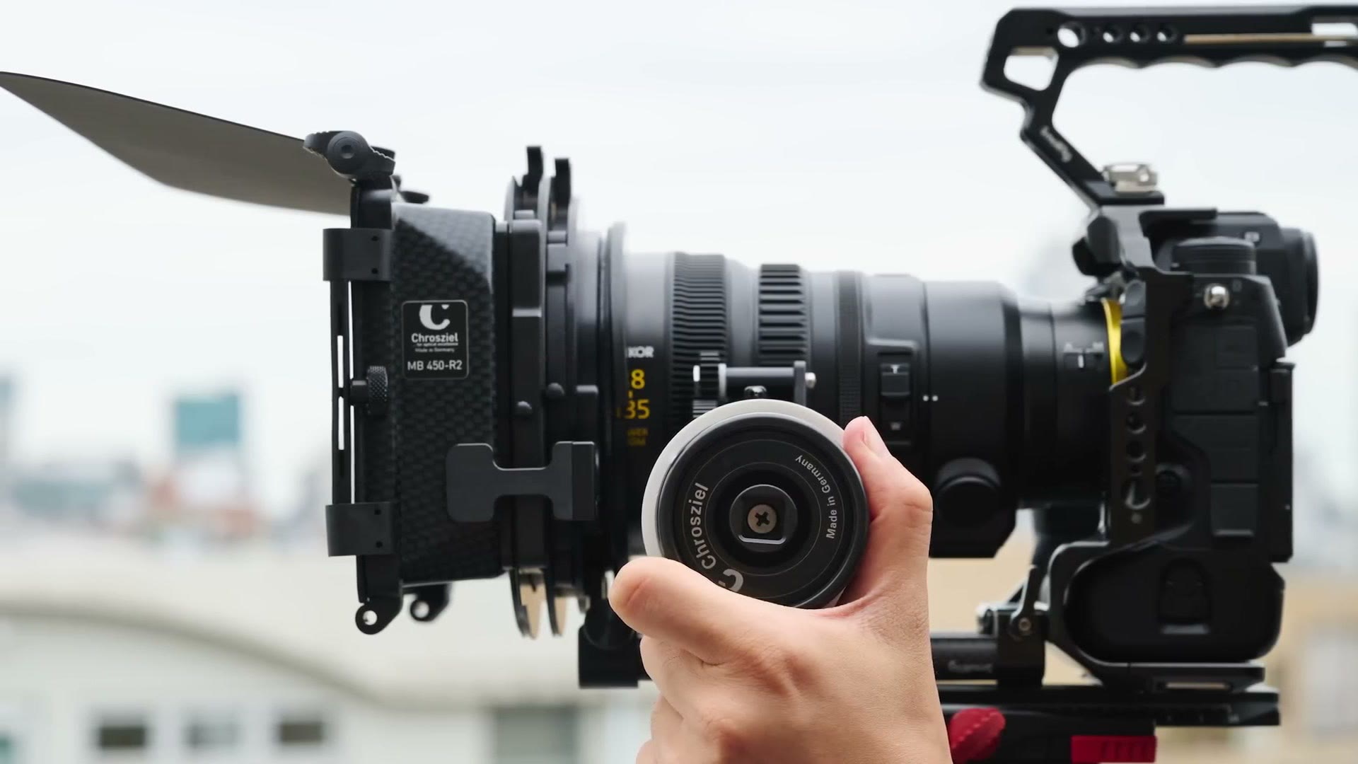 The Nikon 28-135mm power zoom lens rigged on a camera with a Chrosziel matte box and a follow focus attached to the geared focus ring