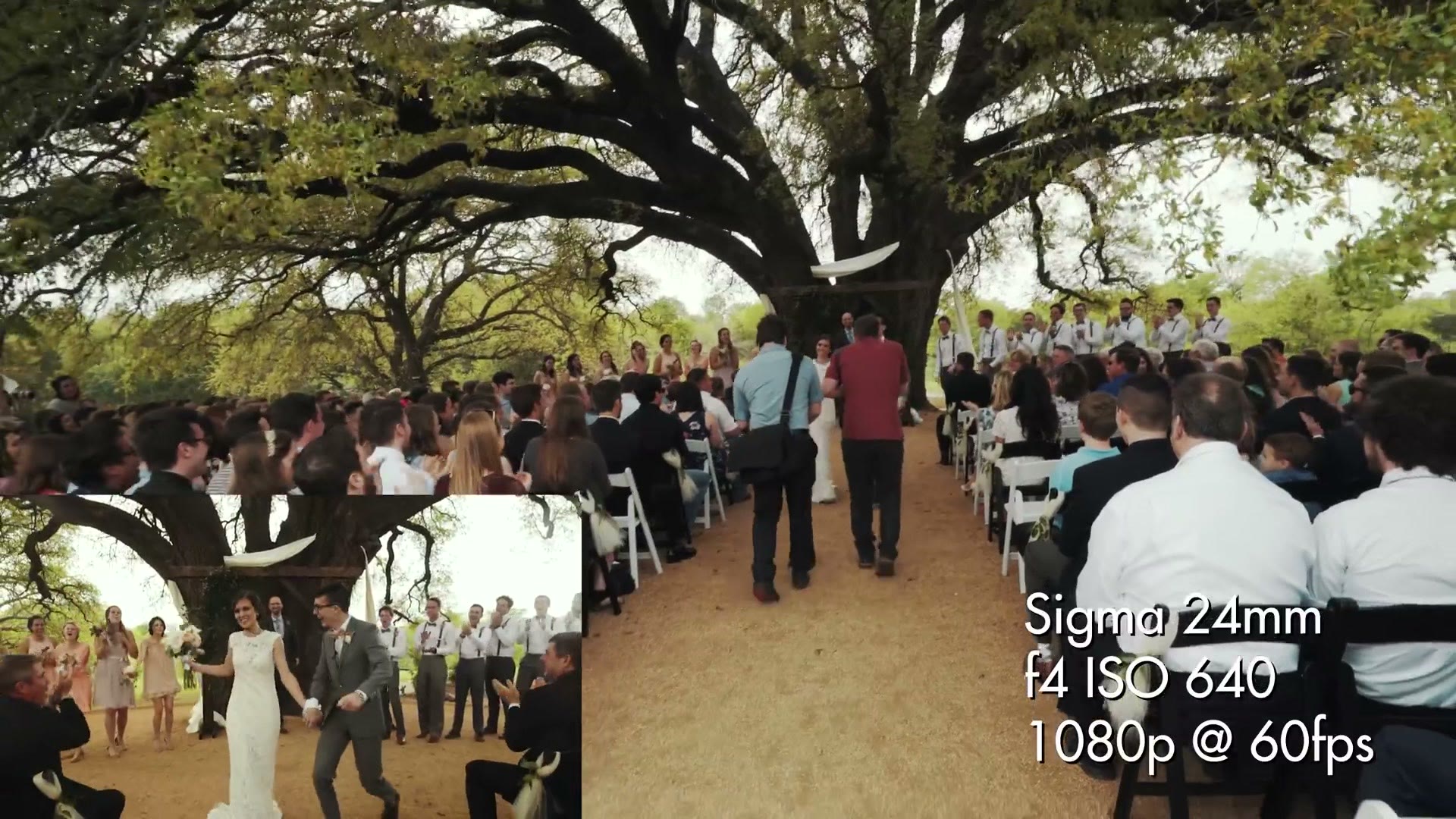 The couple walking back down the aisle after the ceremony while guests stand and applaud