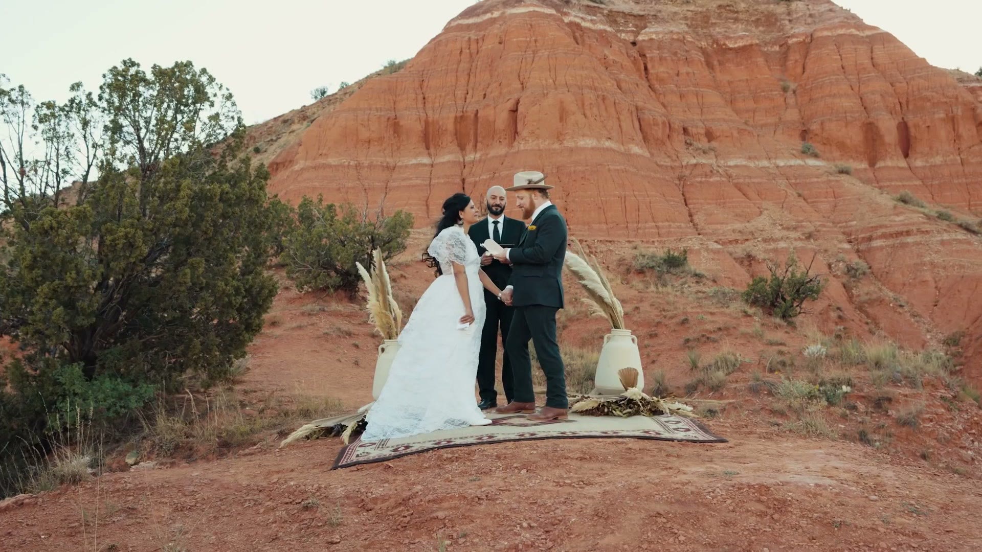 A wedding ceremony in Palo Duro Canyon seen wide against red rock