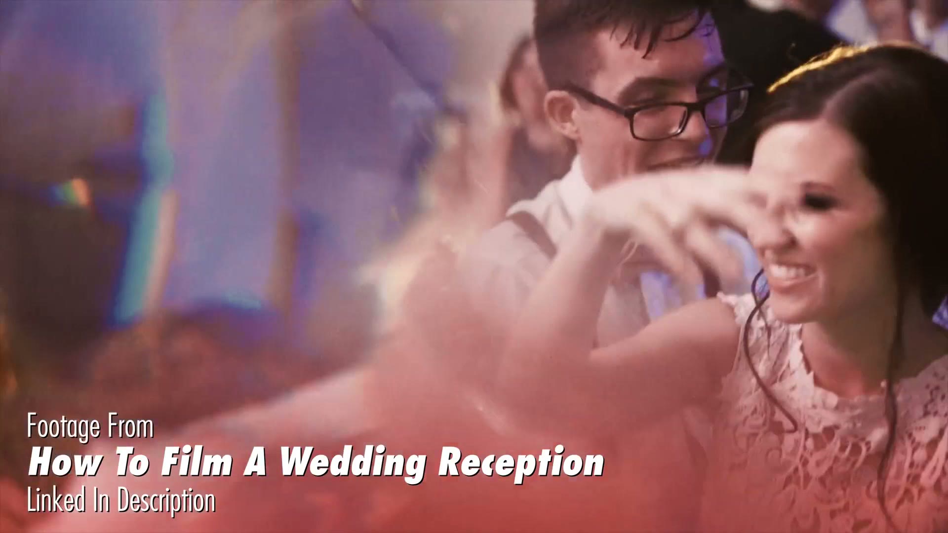 Guests dancing at a wedding reception, with a prism smear of pink and blue light taking over the left two thirds of the frame