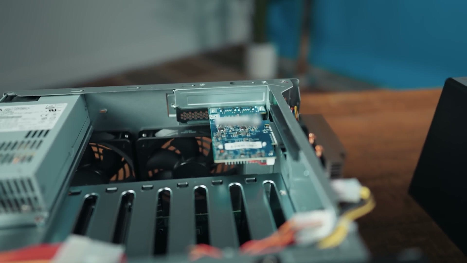 The inside of the QNAP NAS with a ten gigabit Ethernet card being installed in the expansion slot
