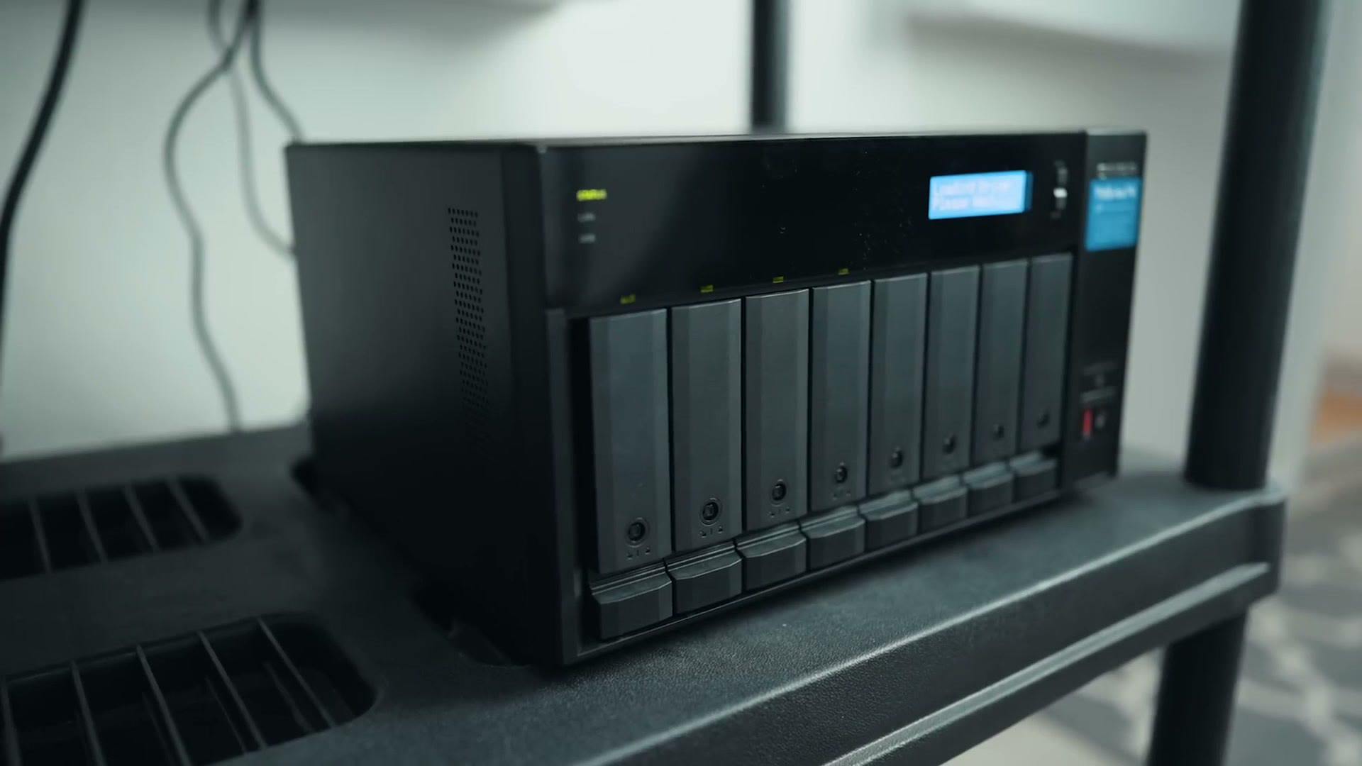 The QNAP NAS on a shelf in a studio