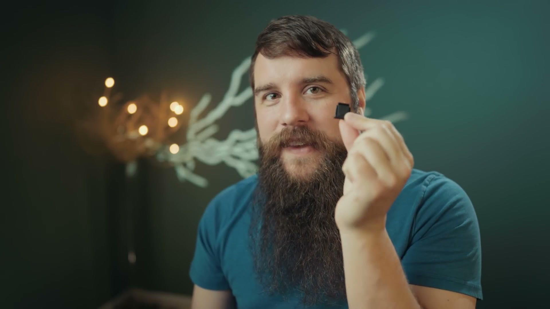 Matt holding up the small black plastic hot shoe cover that ships on Sony mirrorless cameras