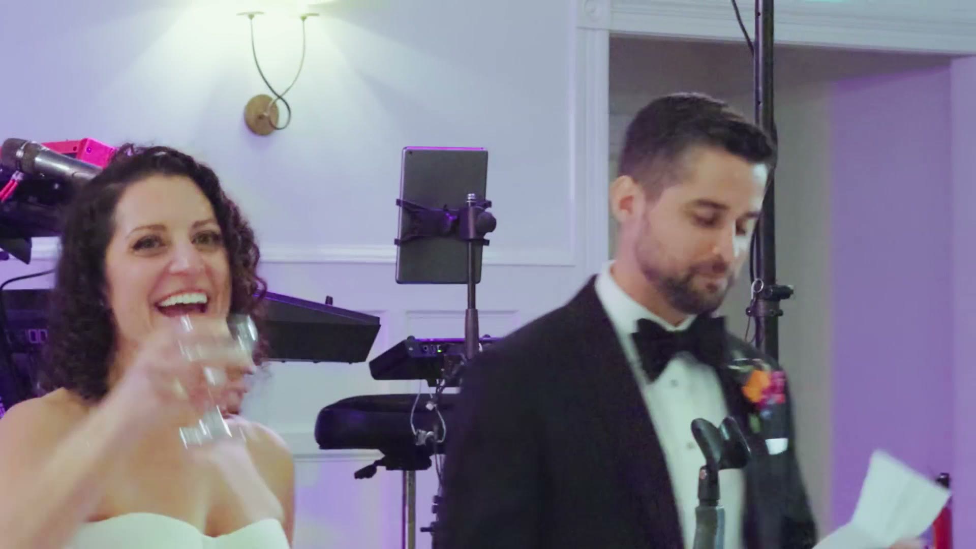 Wedding guests and the couple dancing at the reception, filmed on iPhone in low light