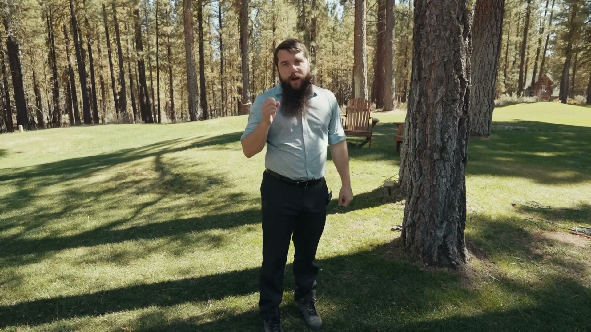 Matt Johnson standing by a tree explaining where he will place his reception light