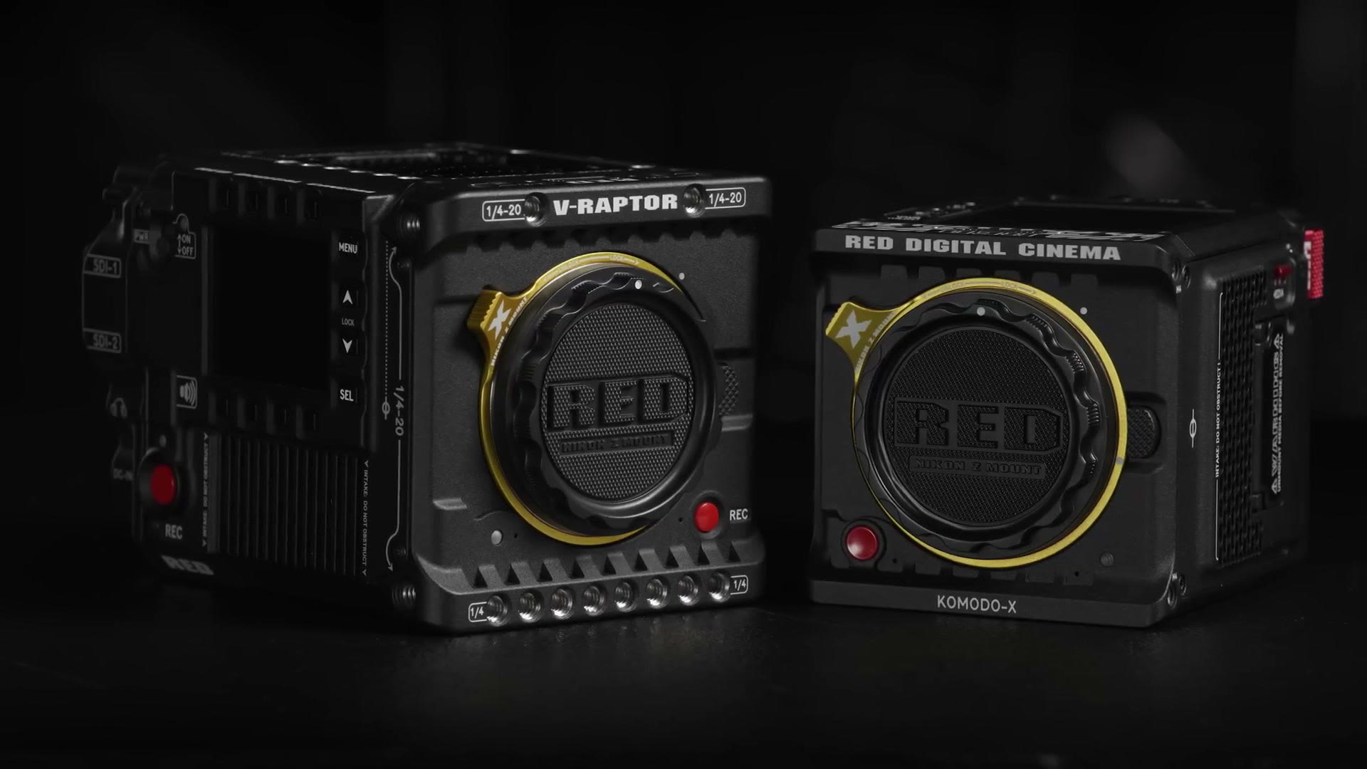 A RED V-Raptor and a RED Komodo X side by side, both fitted with yellow Nikon Z lens mounts