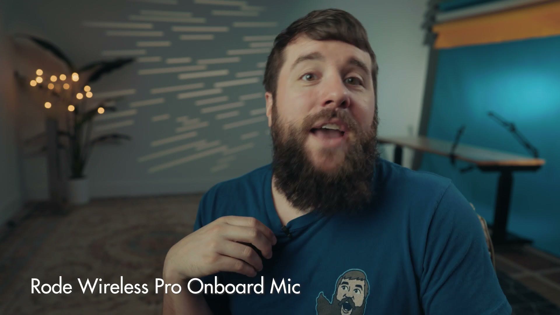 Matt holding a Rode Wireless PRO transmitter up to demonstrate its onboard microphone