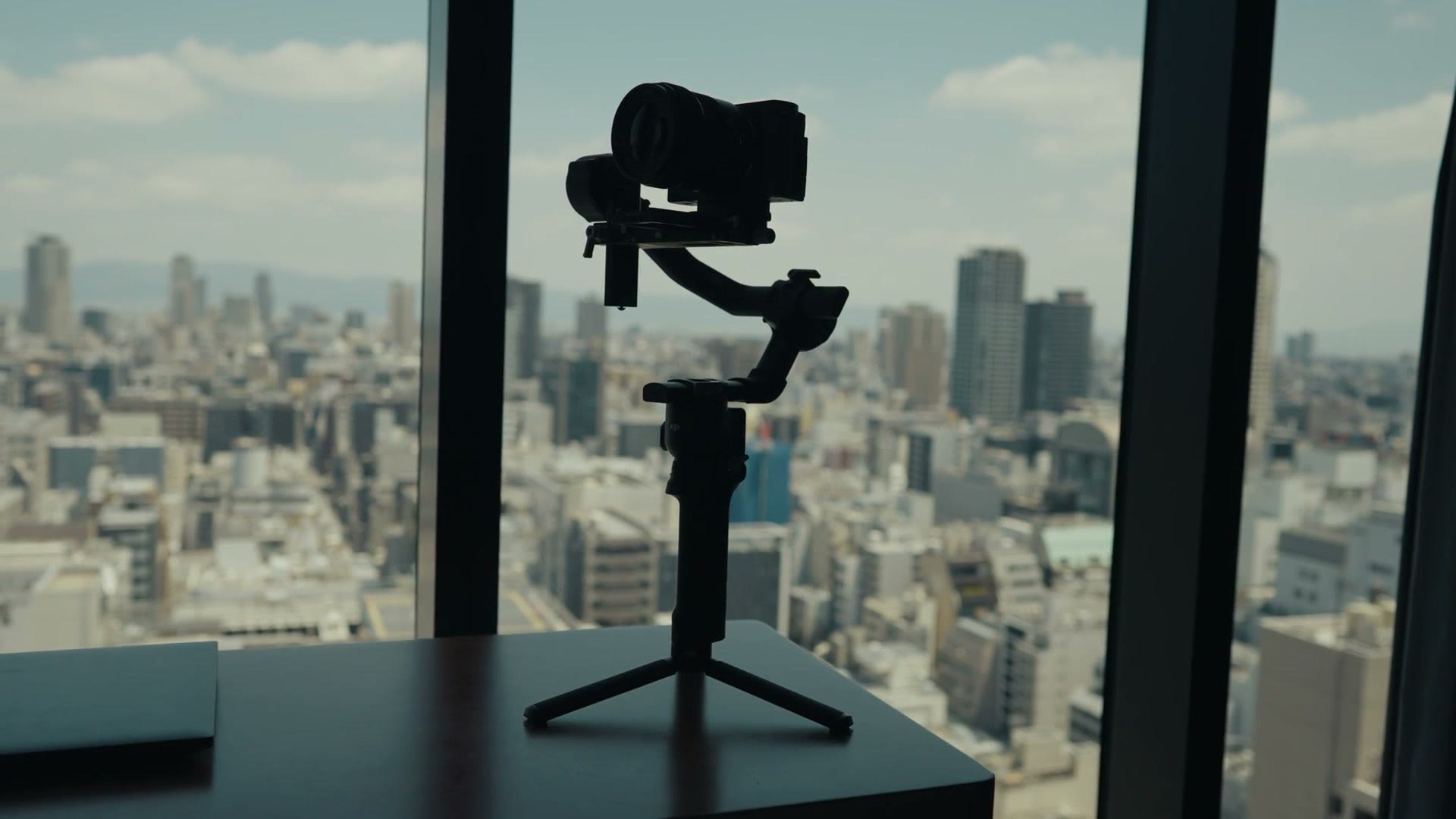 DJI RS4 Pro gimbal with a camera mounted, standing by a window