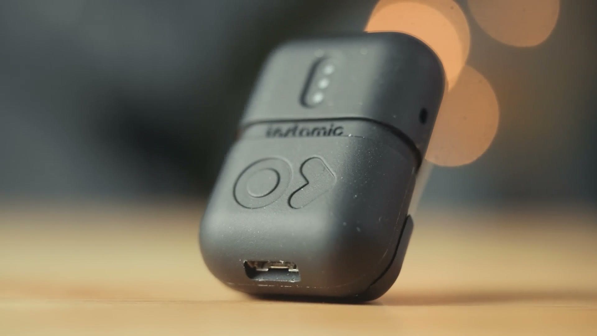 Close up of the original Instamic showing its logo button and micro USB port