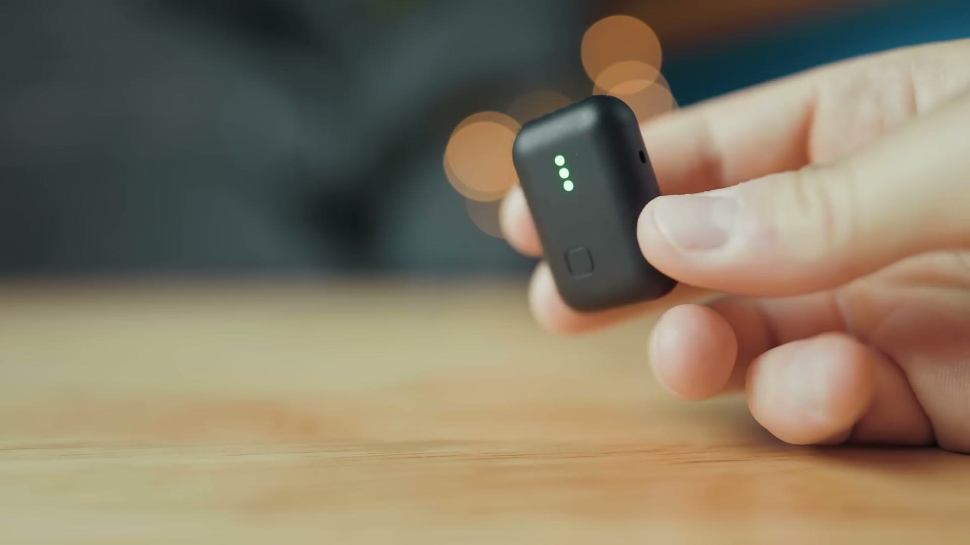 Instamic Pro Plus C held in hand showing the front button and status lights