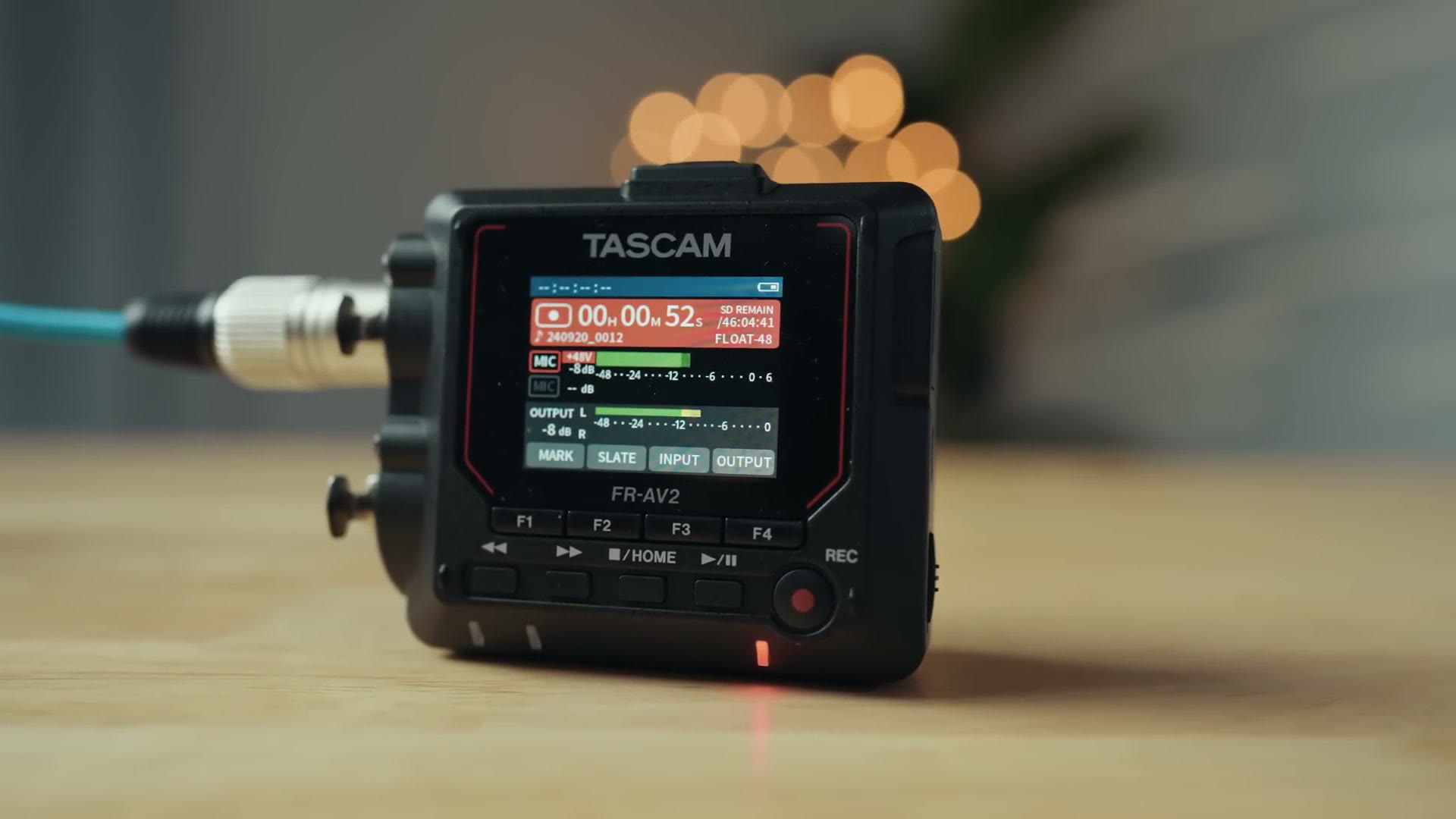 The Tascam FR-AV2 sitting on a desk with an XLR cable plugged in