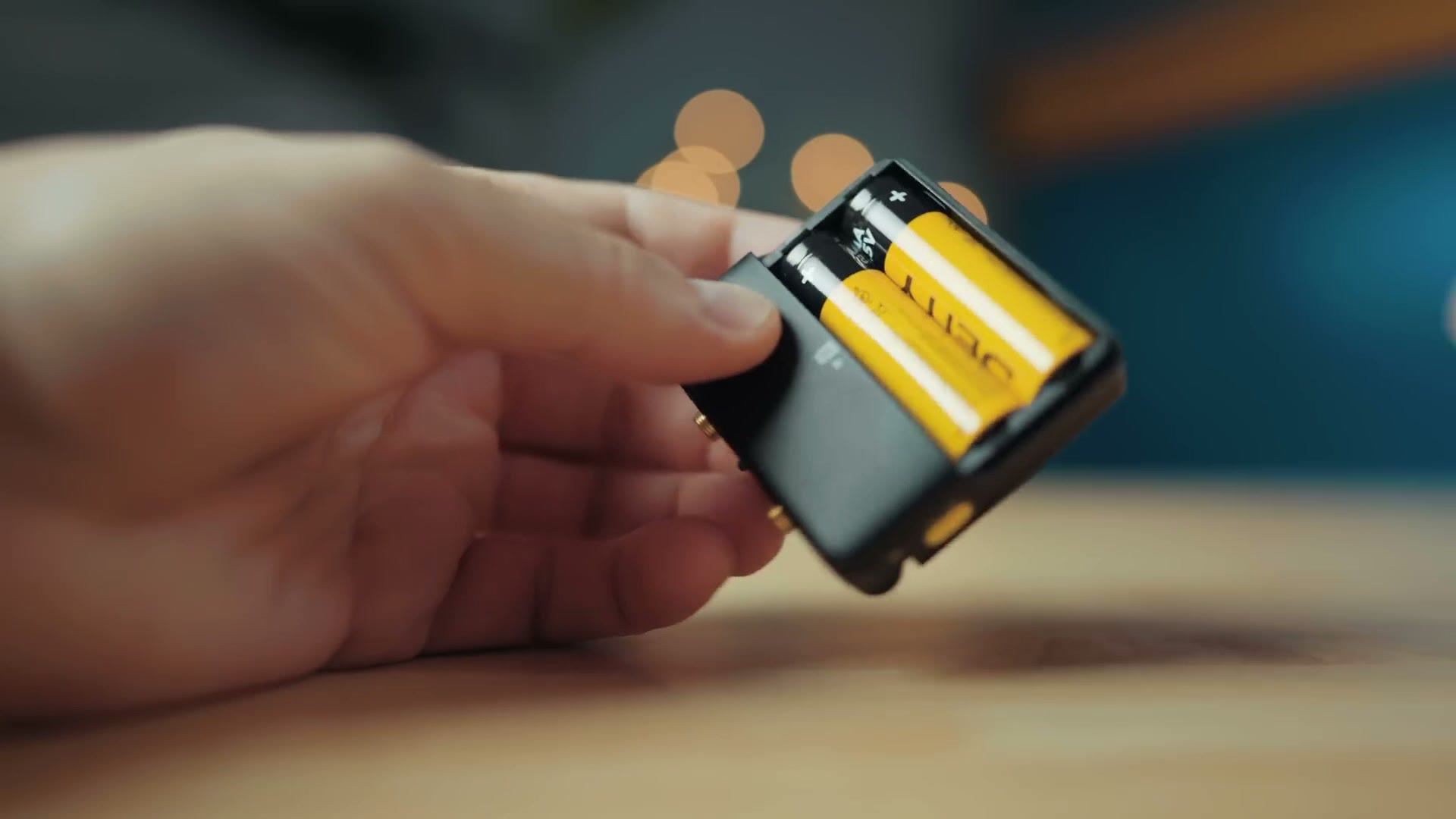 Battery door open on the Deity PR-2 showing two AA batteries