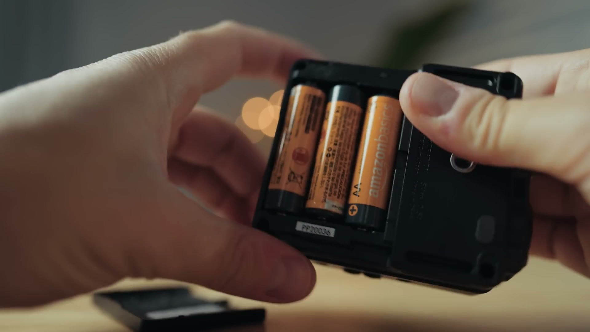 Battery door open on the Tascam FR-AV2 showing three AA batteries
