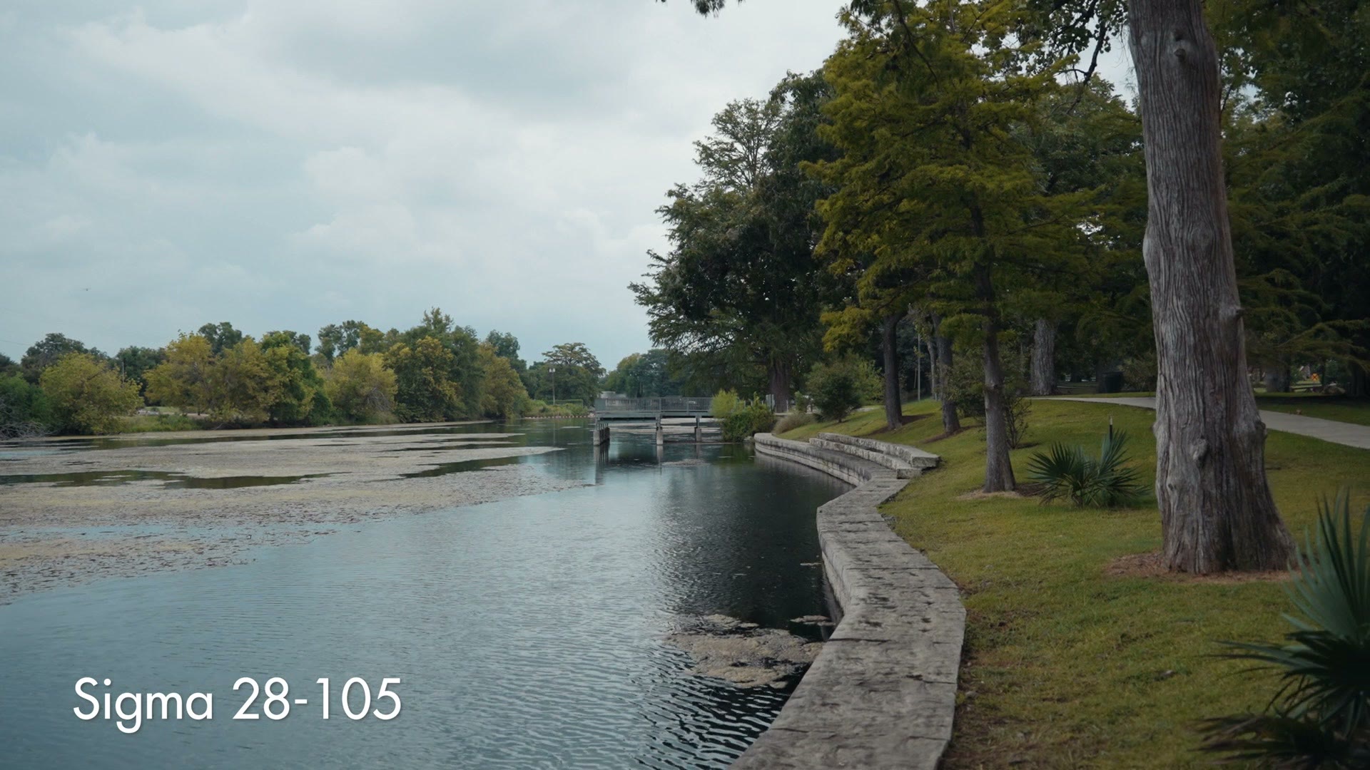 Sigma 28-105 sample frame of a park pathway beside a river