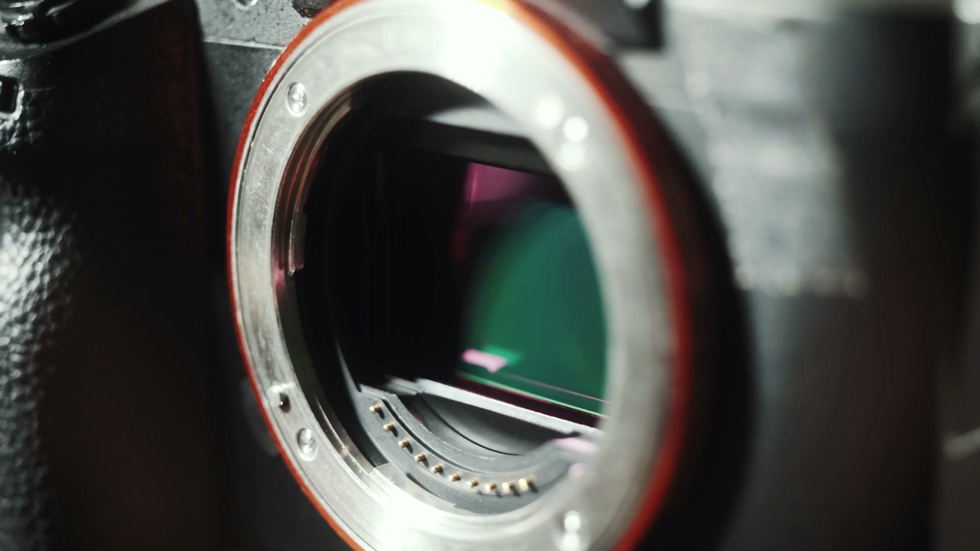Close-up of the open lens mount of a Sony mirrorless camera with the bare sensor visible inside.