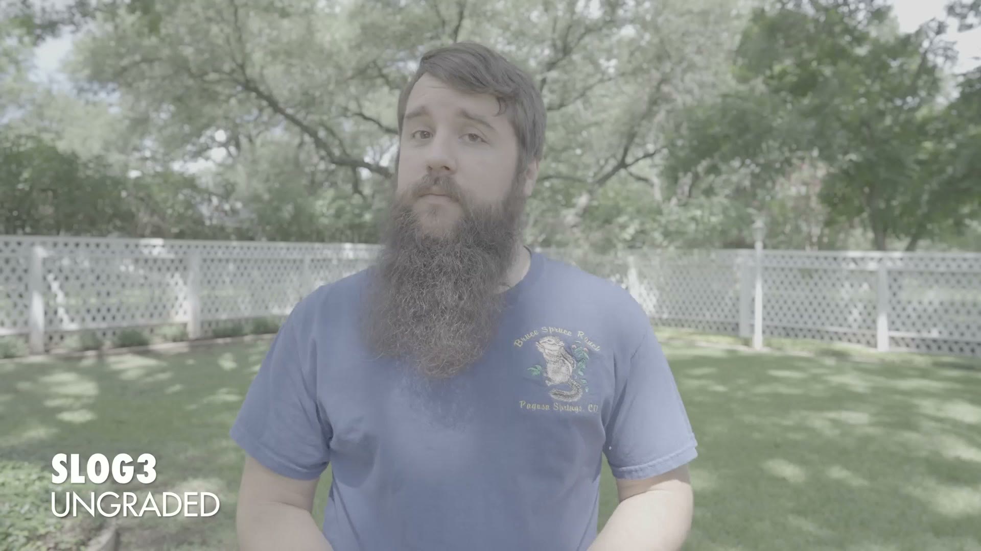 A flat, desaturated shot of Matt standing in a sunlit backyard, labelled SLOG3 UNGRADED