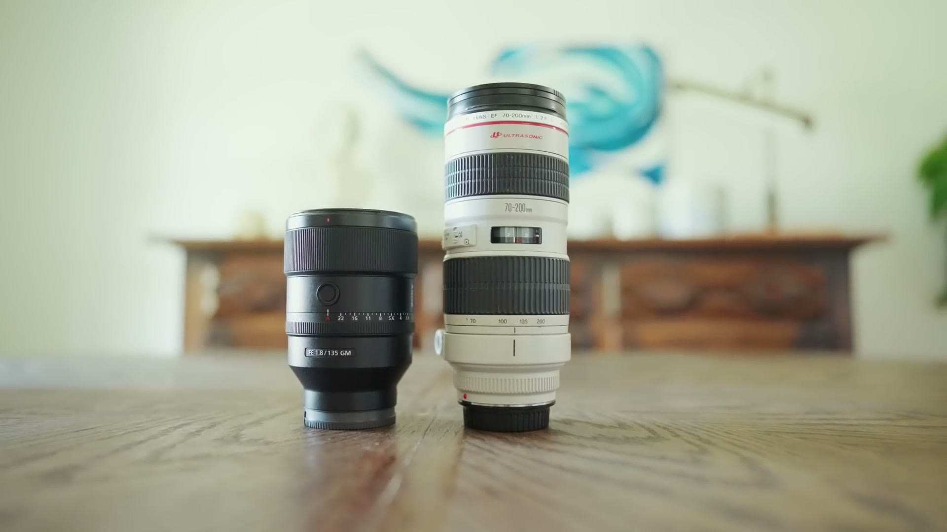 The Sony 135mm GM standing next to a 70-200mm lens for size comparison
