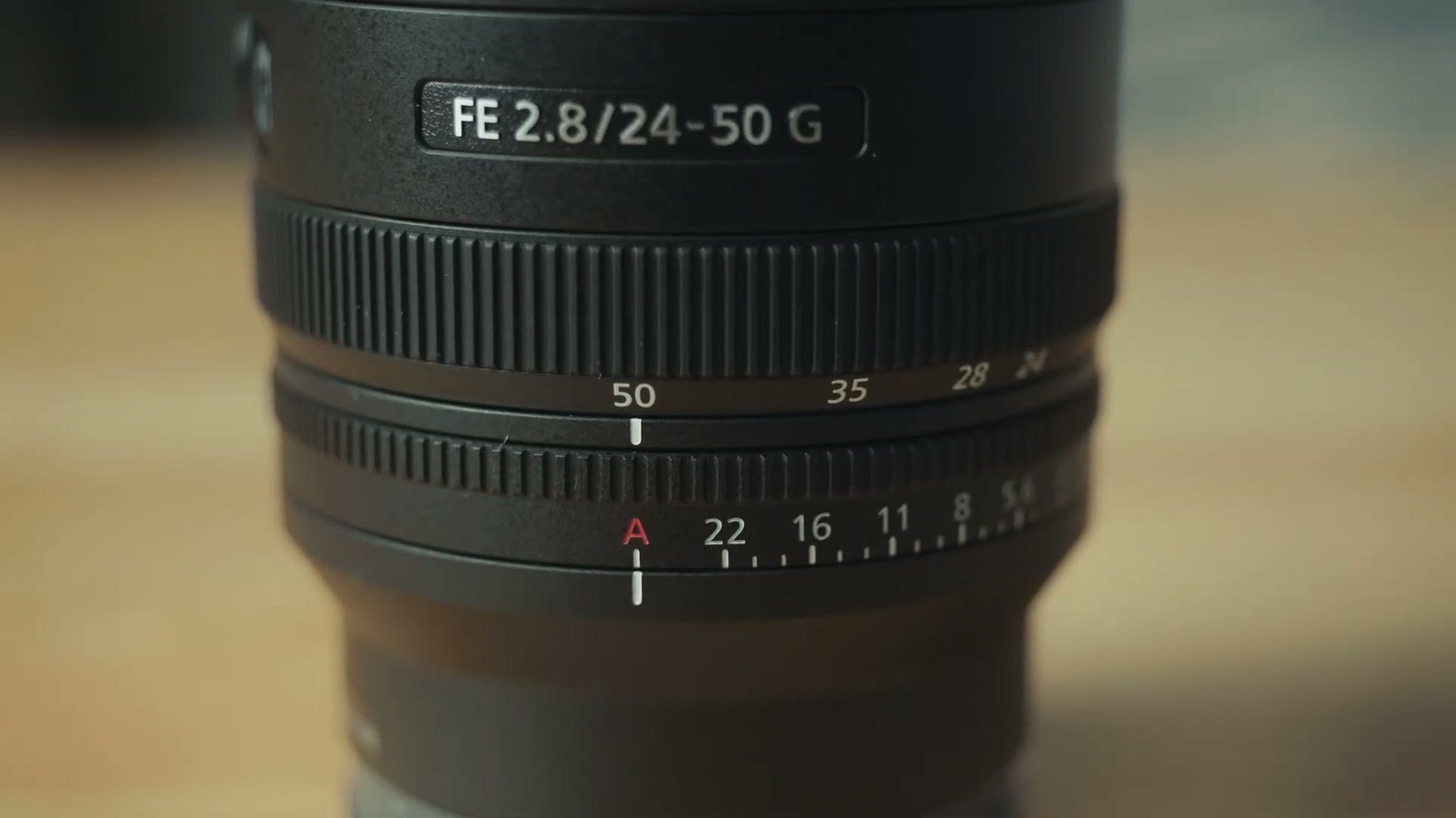 Aperture ring and zoom scale markings on the Sony 24-50mm f/2.8 G