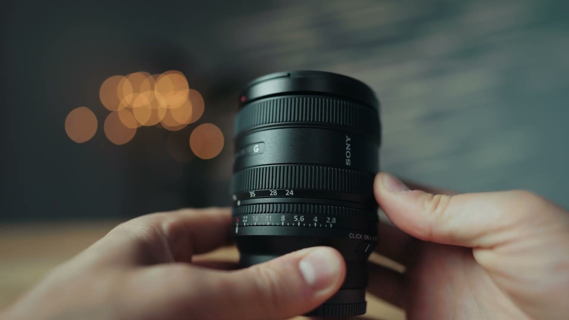 Sony 24-50mm f/2.8 G held in hand in its most compact position